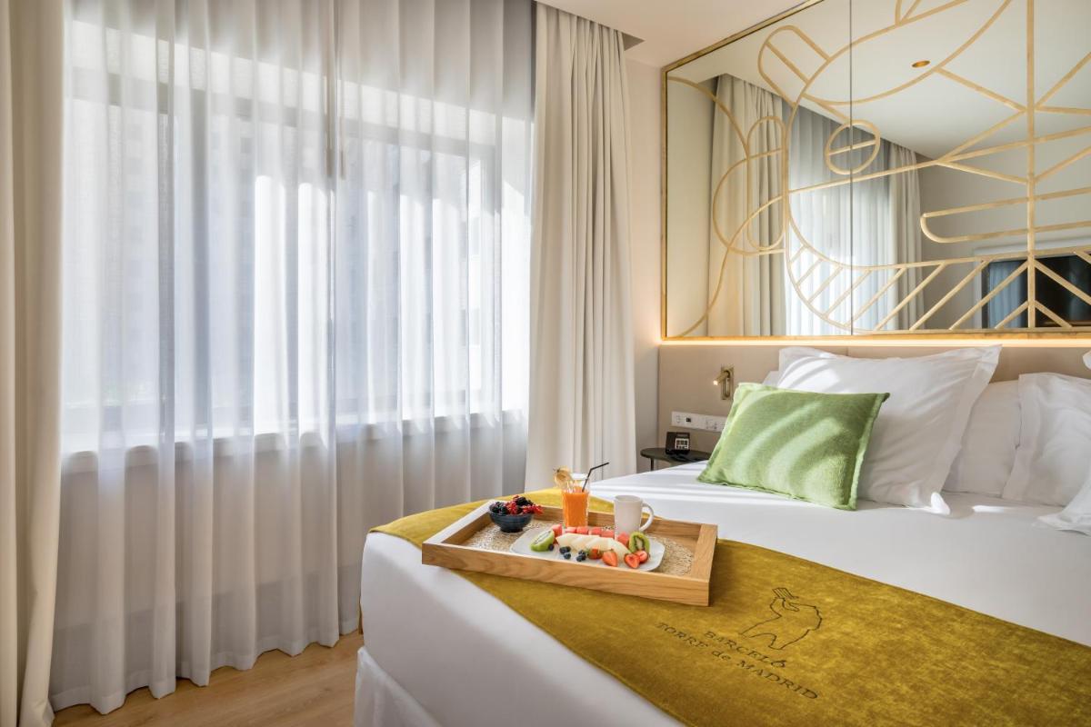Cama o camas de una habitación en Barceló Torre de Madrid