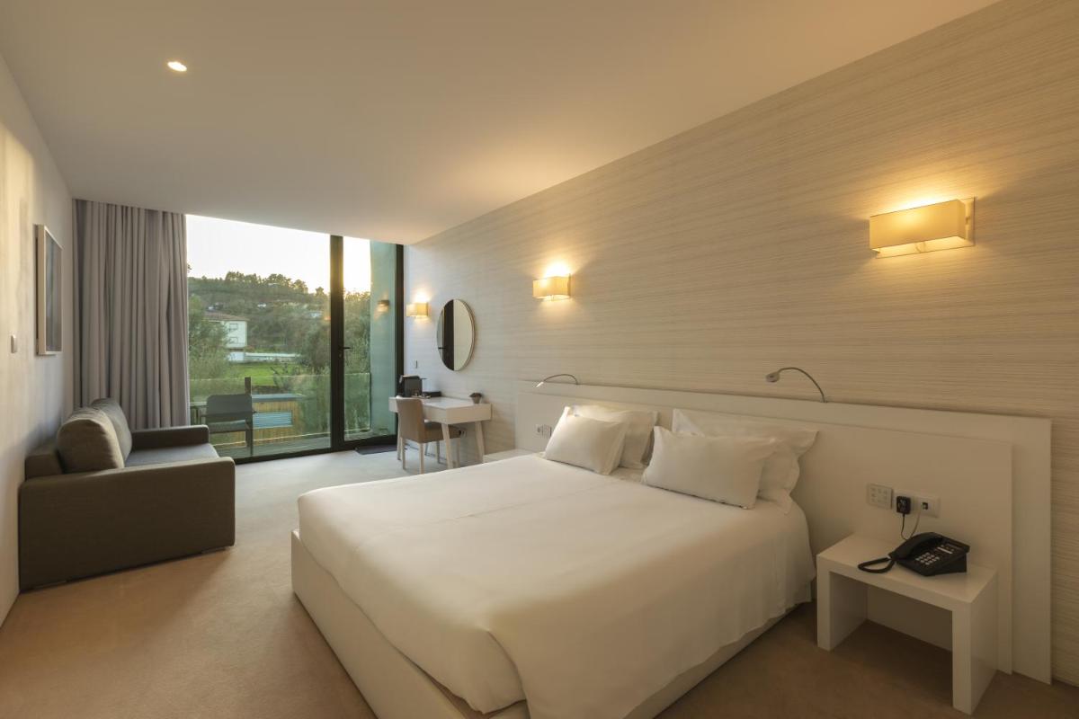 Uma cama ou camas num quarto em Tempus Hotel & Spa