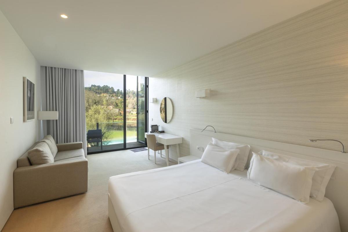 Uma cama ou camas num quarto em Tempus Hotel & Spa