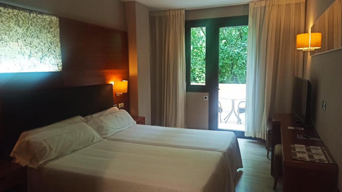 Cama o camas de una habitación en Hotel Balneario Valle del Jerte