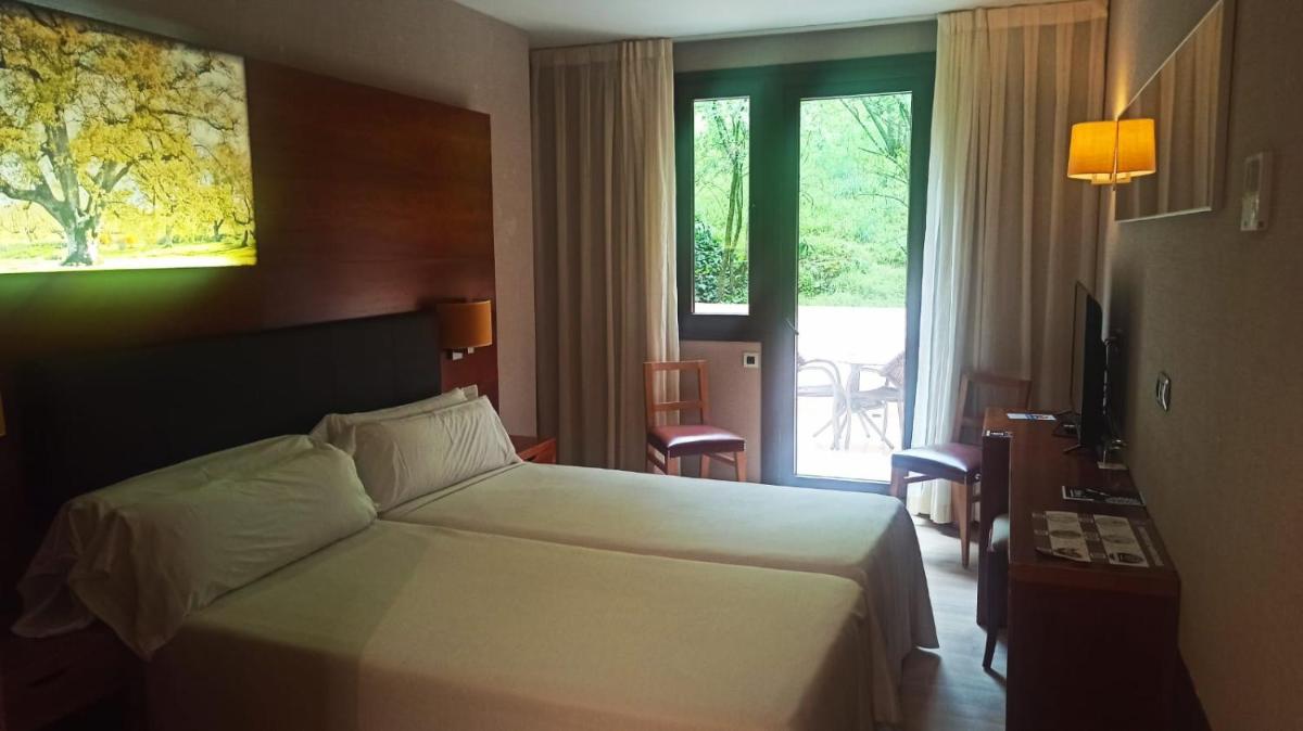 Cama o camas de una habitación en Hotel Balneario Valle del Jerte
