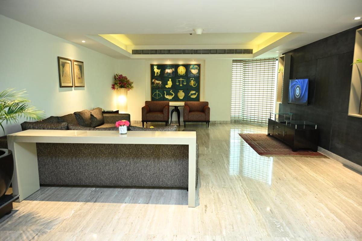 a living room with a couch and a table at The LaLiT New Delhi in New Delhi