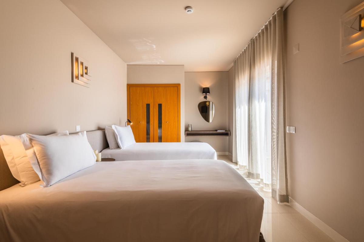 Uma cama ou camas num quarto em Vale da Lapa Village Resort