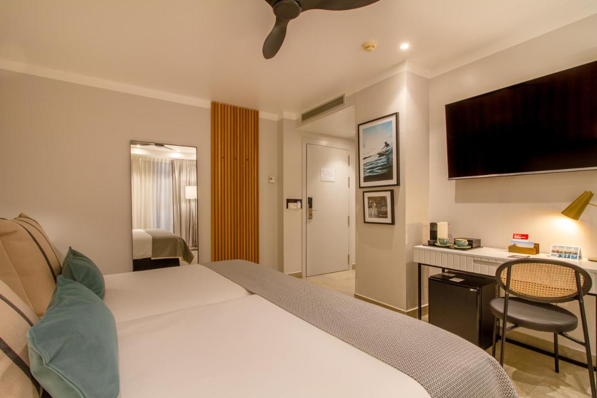 Cama o camas de una habitación en SOLYMAR Gran Hotel