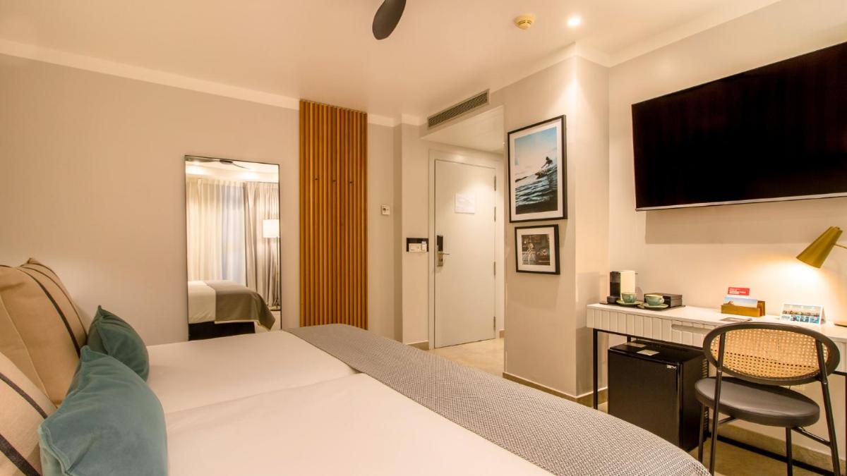 Cama o camas de una habitación en SOLYMAR Gran Hotel