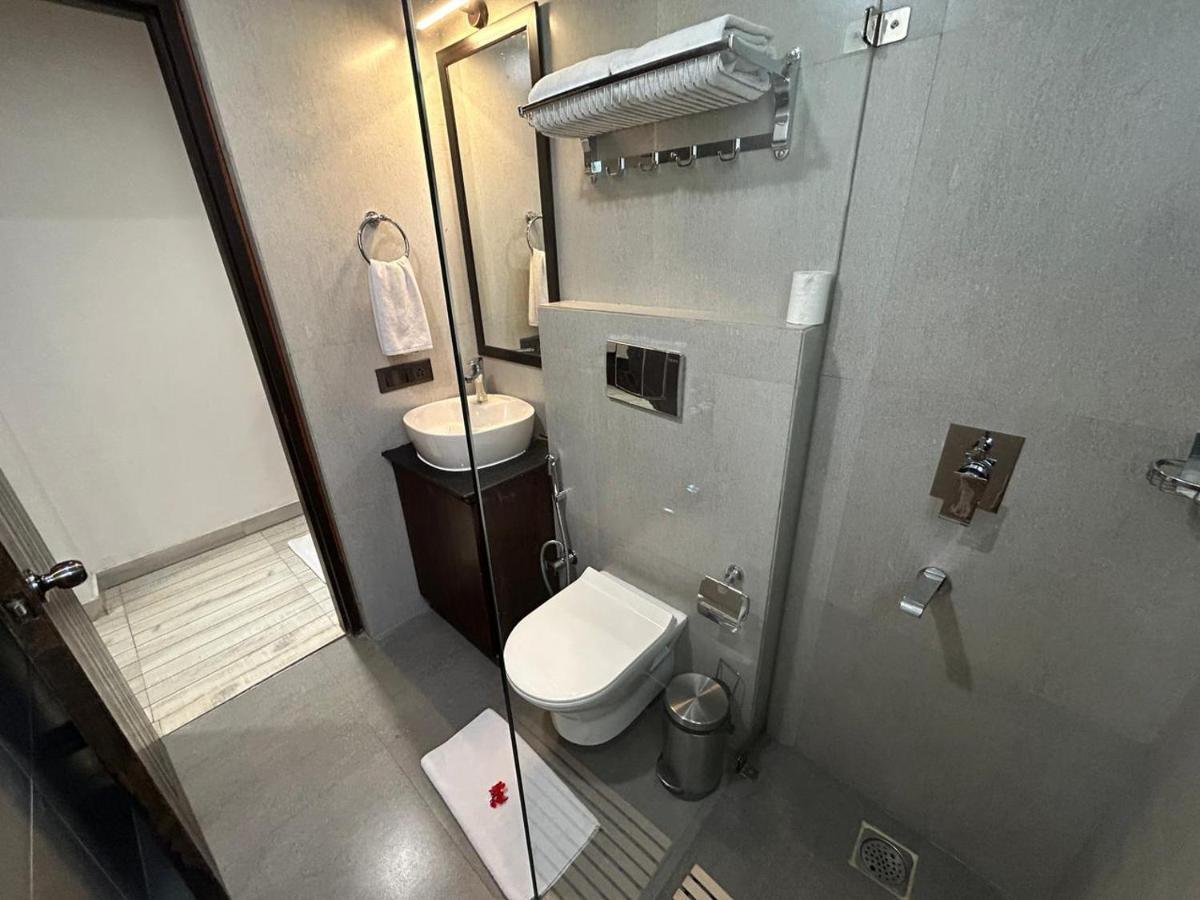 a small bathroom with a toilet and a sink at The Orchid Shimla in Shimla