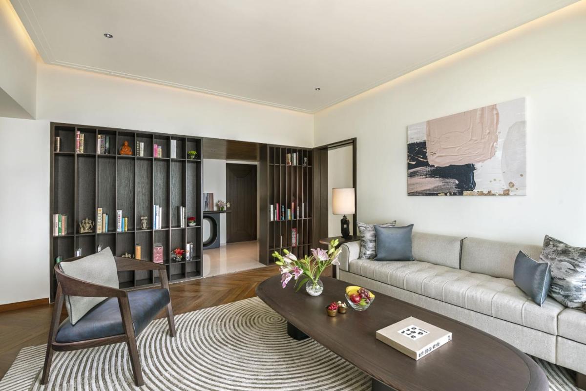 a living room with a couch and a table at The Oberoi Mumbai in Mumbai