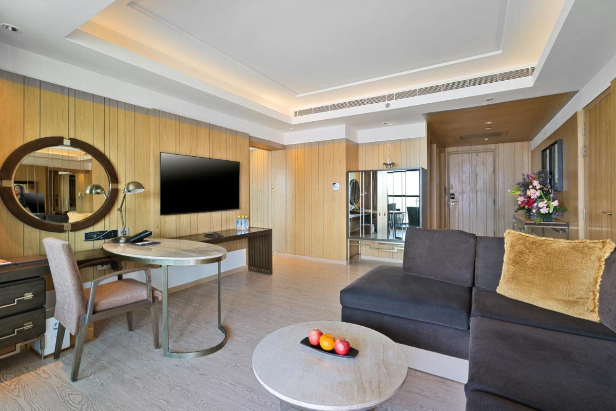 a living room with a couch and a table at JW Marriott Mussoorie Walnut Grove Resort & Spa in Mussoorie