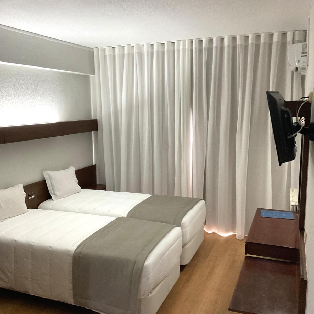 Uma cama ou camas num quarto em Hotel Costa de Prata 2 & Spa