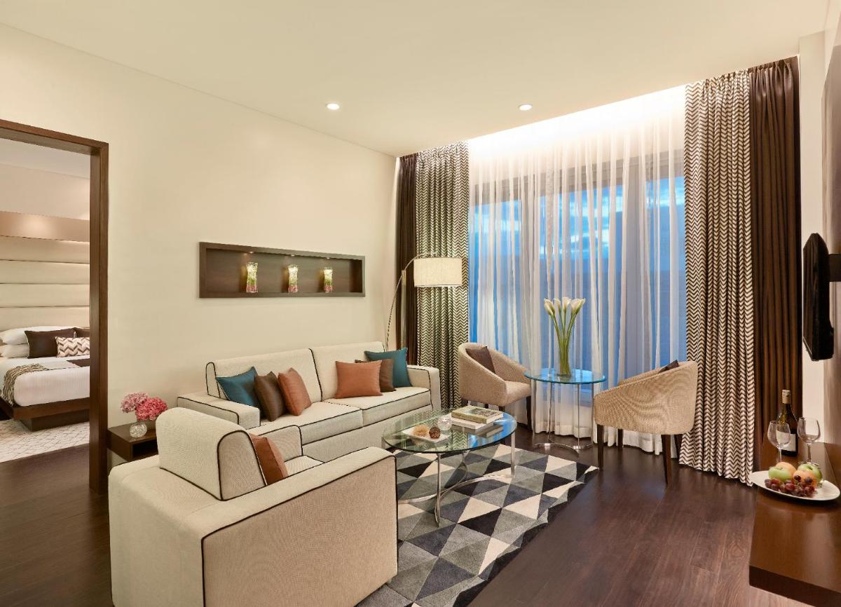 a living room with a couch and a table at Vivanta Pune, Hinjawadi in Pune