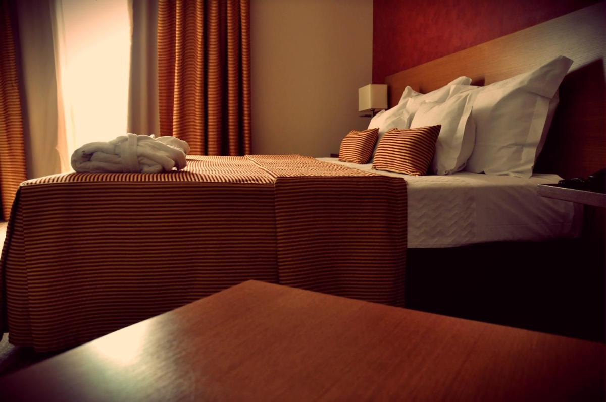Uma cama ou camas num quarto em Hotel Lusitania Congress & Spa