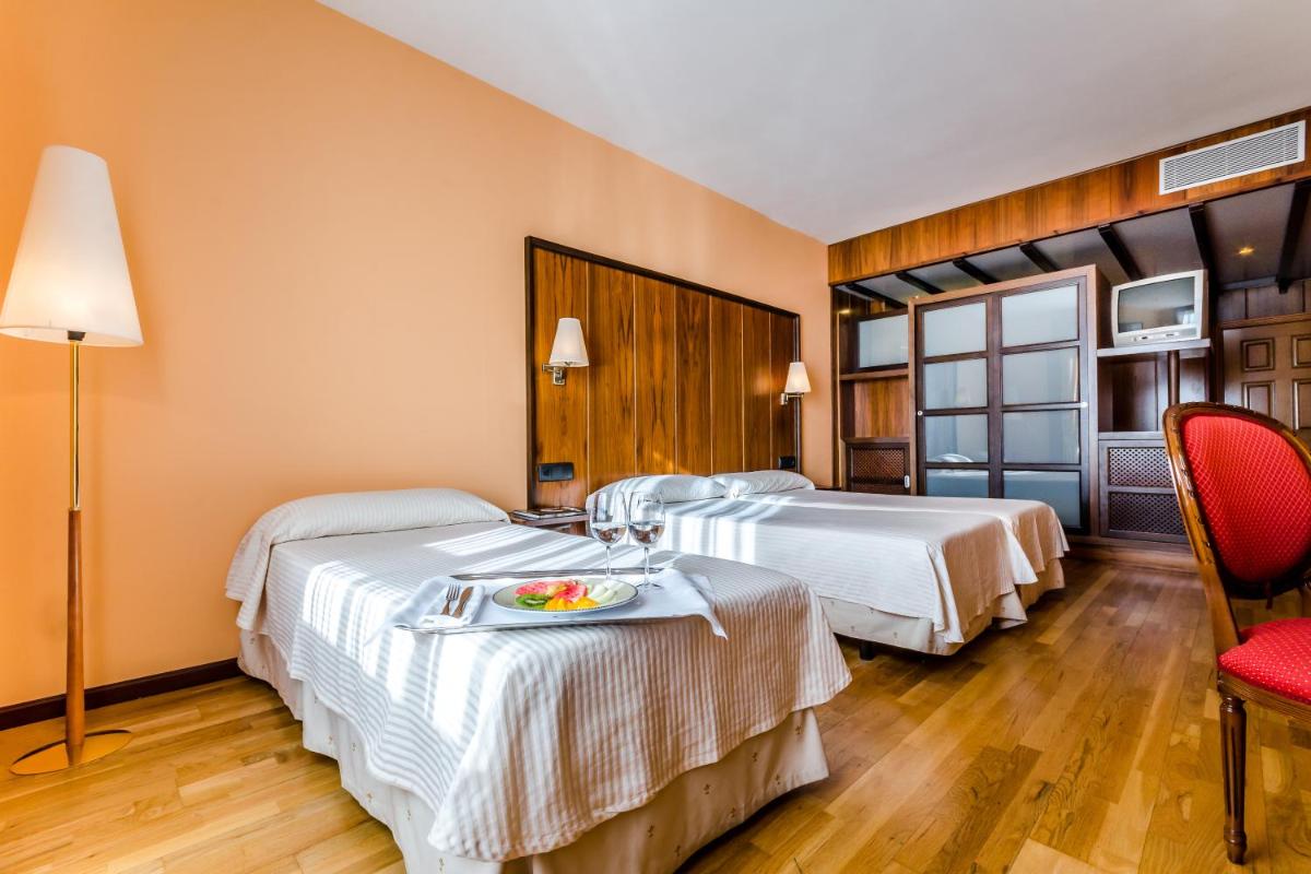 Cama o camas de una habitación en Hotel Doña Brígida – Salamanca Forum