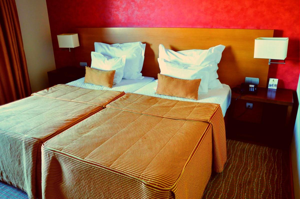 Uma cama ou camas num quarto em Hotel Lusitania Congress & Spa