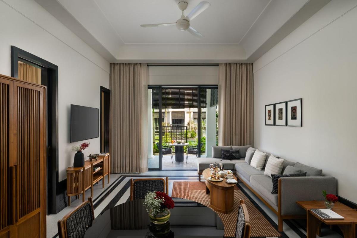 a living room with a couch and a table at Taj Taal Kutir in Kolkata