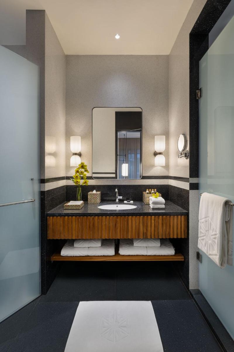 a bathroom with a sink and a mirror at Taj Taal Kutir in Kolkata