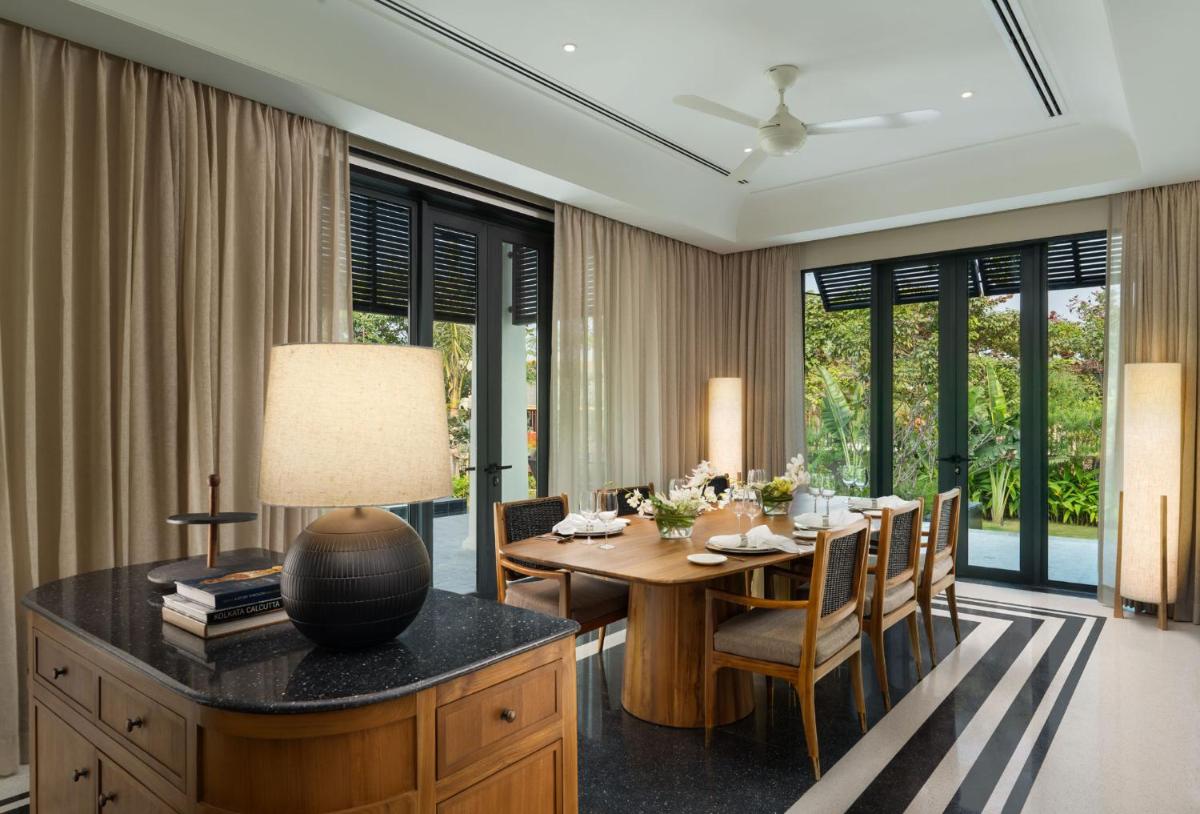 a dining room with a table and chairs at Taj Taal Kutir in Kolkata