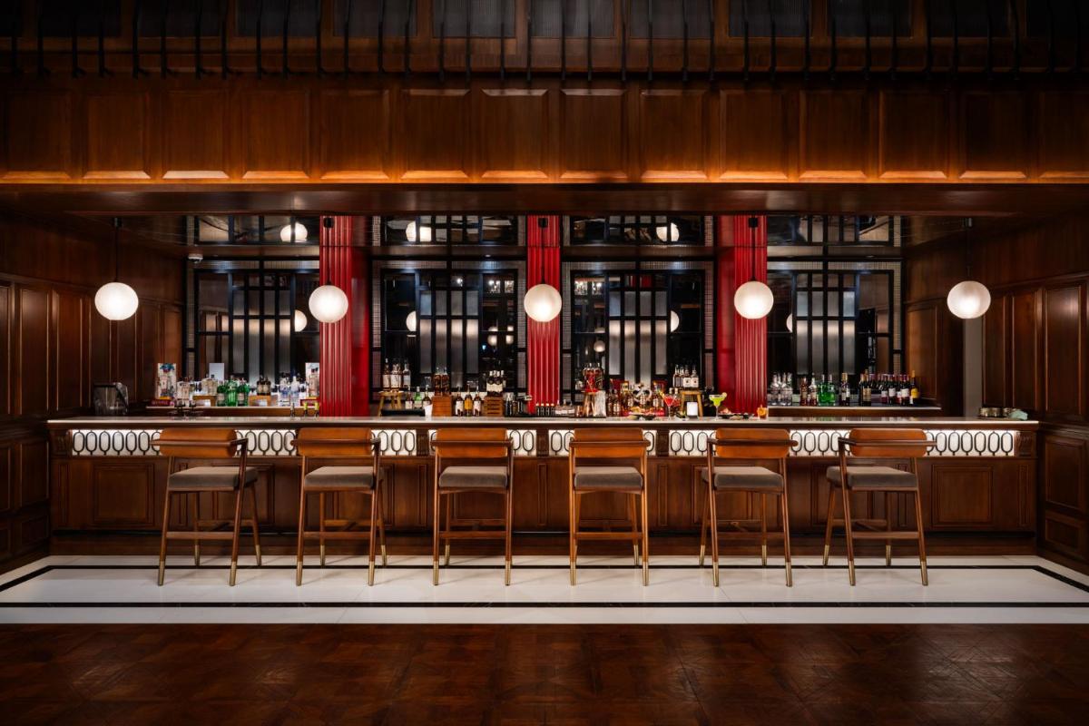 a rendering of a bar with chairs in a room at Taj Taal Kutir in Kolkata