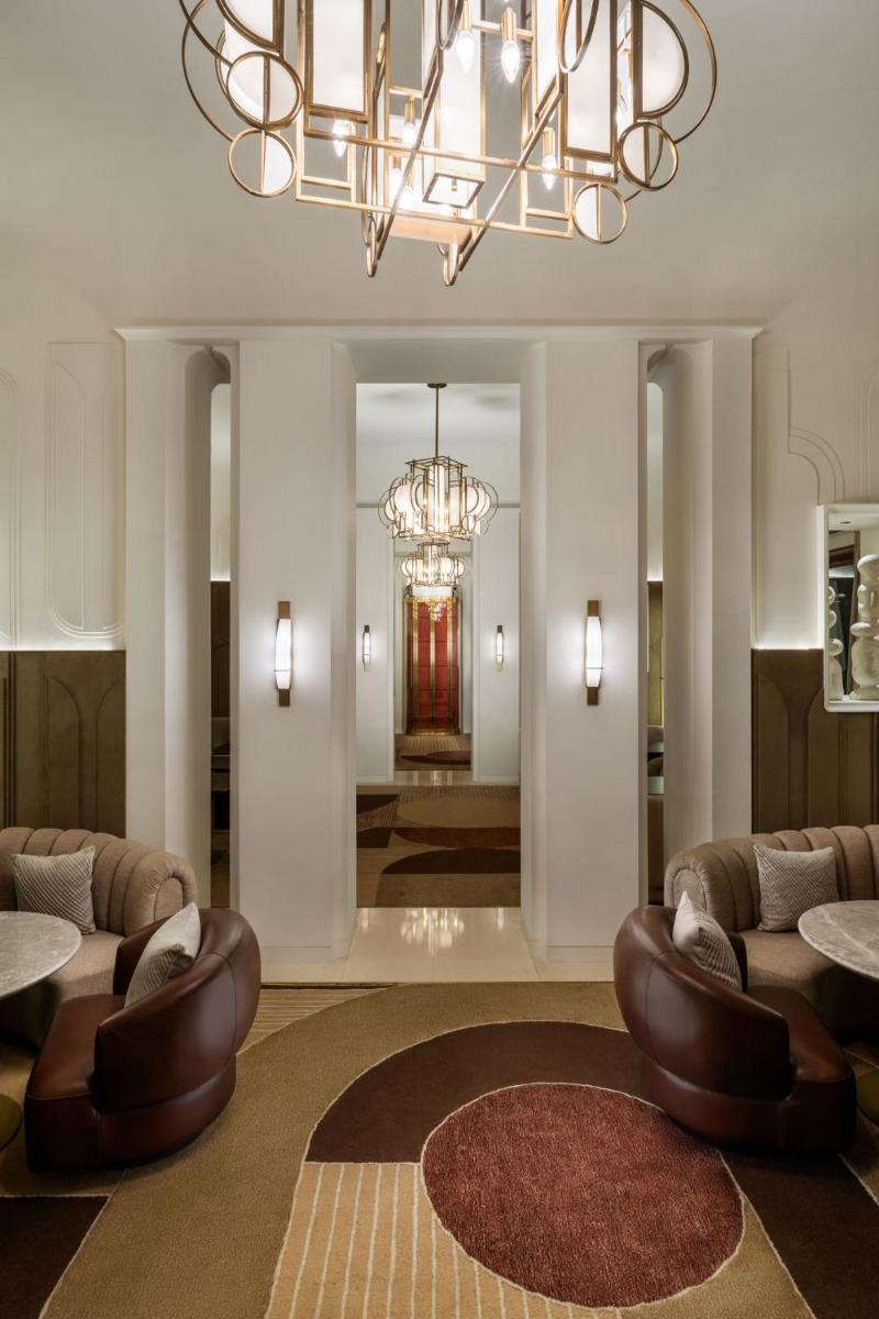 a lobby with couches and a chandelier at Taj Taal Kutir in Kolkata