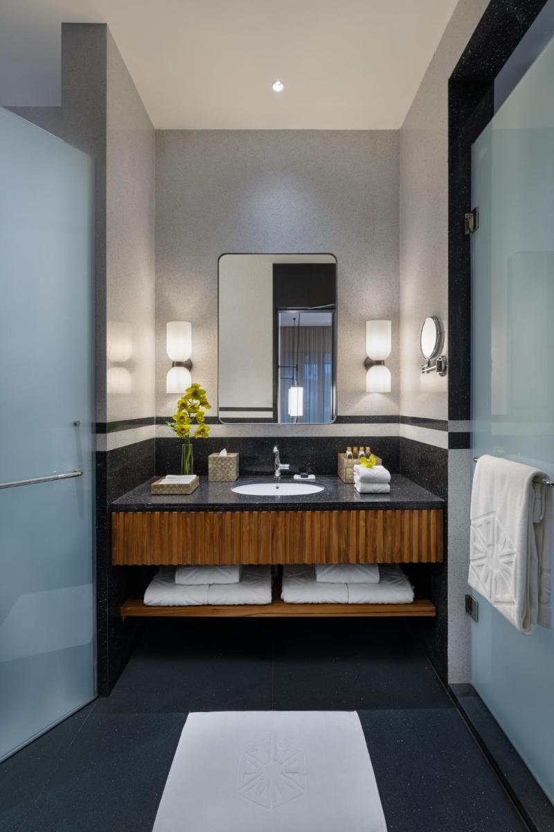 a bathroom with a sink and a mirror at Taj Taal Kutir in Kolkata