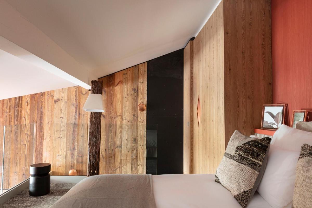 Un ou plusieurs lits dans un hébergement de l'établissement Grandes Rousses Hotel & Spa