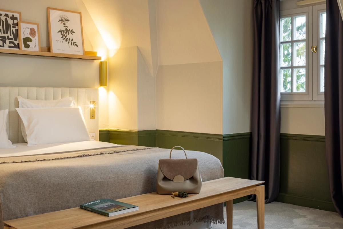 Un ou plusieurs lits dans un hébergement de l'établissement Briqueterie Champagne, A Beauvallon Hotel