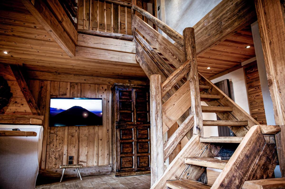 Télévision ou salle de divertissement dans l'établissement Zannier Le Chalet