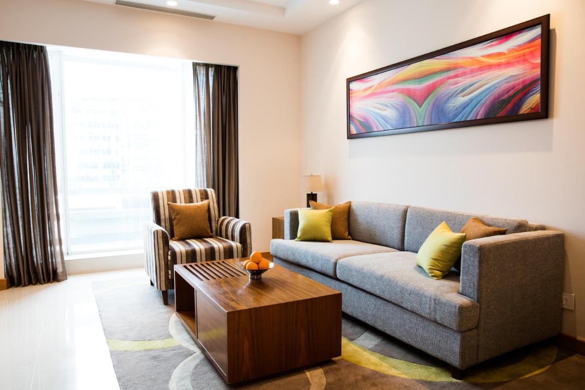 a living room with a couch and a table at Oakwood Residence Kapil Hyderabad in Hyderabad