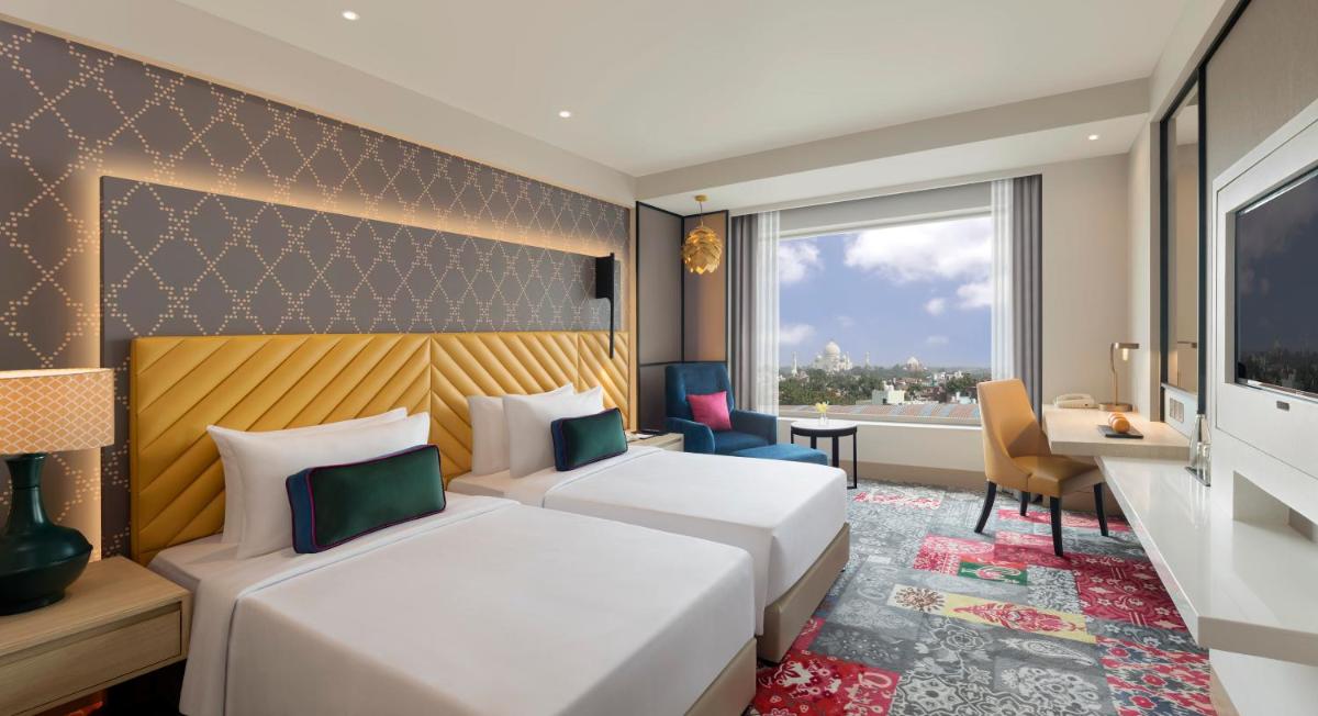 a hotel room with two beds and a window at Grand Mercure Agra - An Accor Brand in Agra