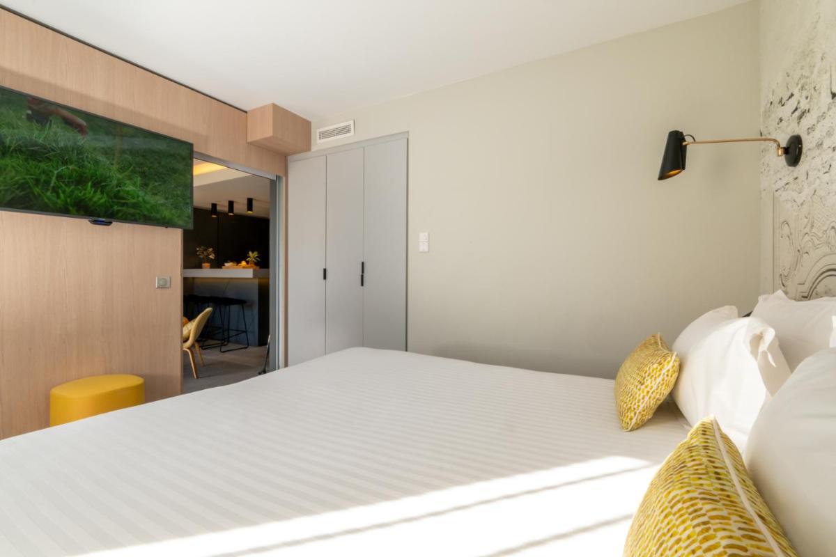 Un ou plusieurs lits dans un hébergement de l'établissement Nemea Appart Hotel Cannes Palais