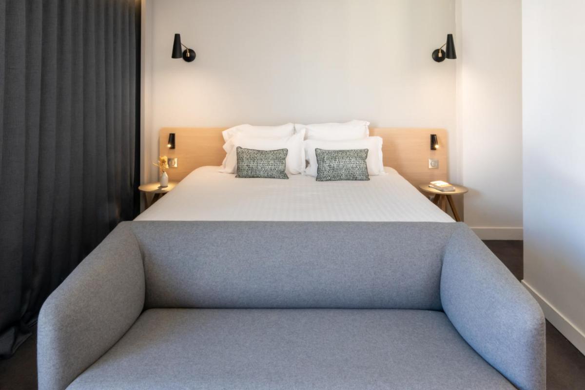 Un ou plusieurs lits dans un hébergement de l'établissement Nemea Appart Hotel Cannes Palais