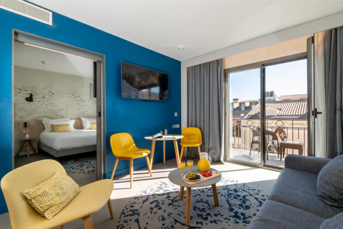 Un ou plusieurs lits dans un hébergement de l'établissement Nemea Appart Hotel Cannes Palais