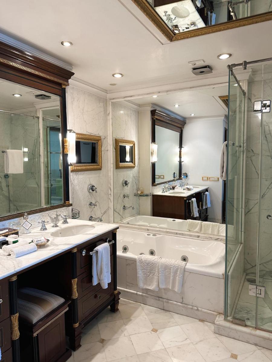 a bathroom with a tub and a sink and a shower at The Raj Palace (Small Luxury Hotels of the World) in Jaipur
