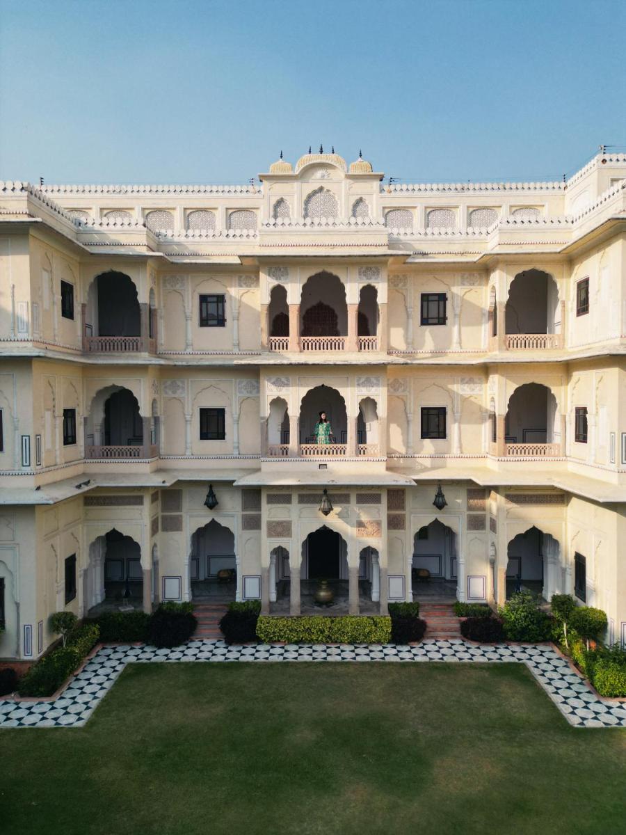 a large building with a lawn in front of it at The Raj Palace (Small Luxury Hotels of the World) in Jaipur