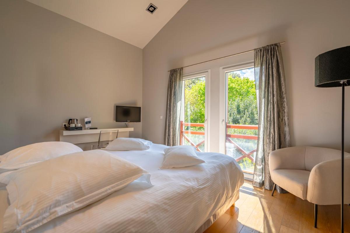 Un ou plusieurs lits dans un hébergement de l'établissement Lafitenia Resort