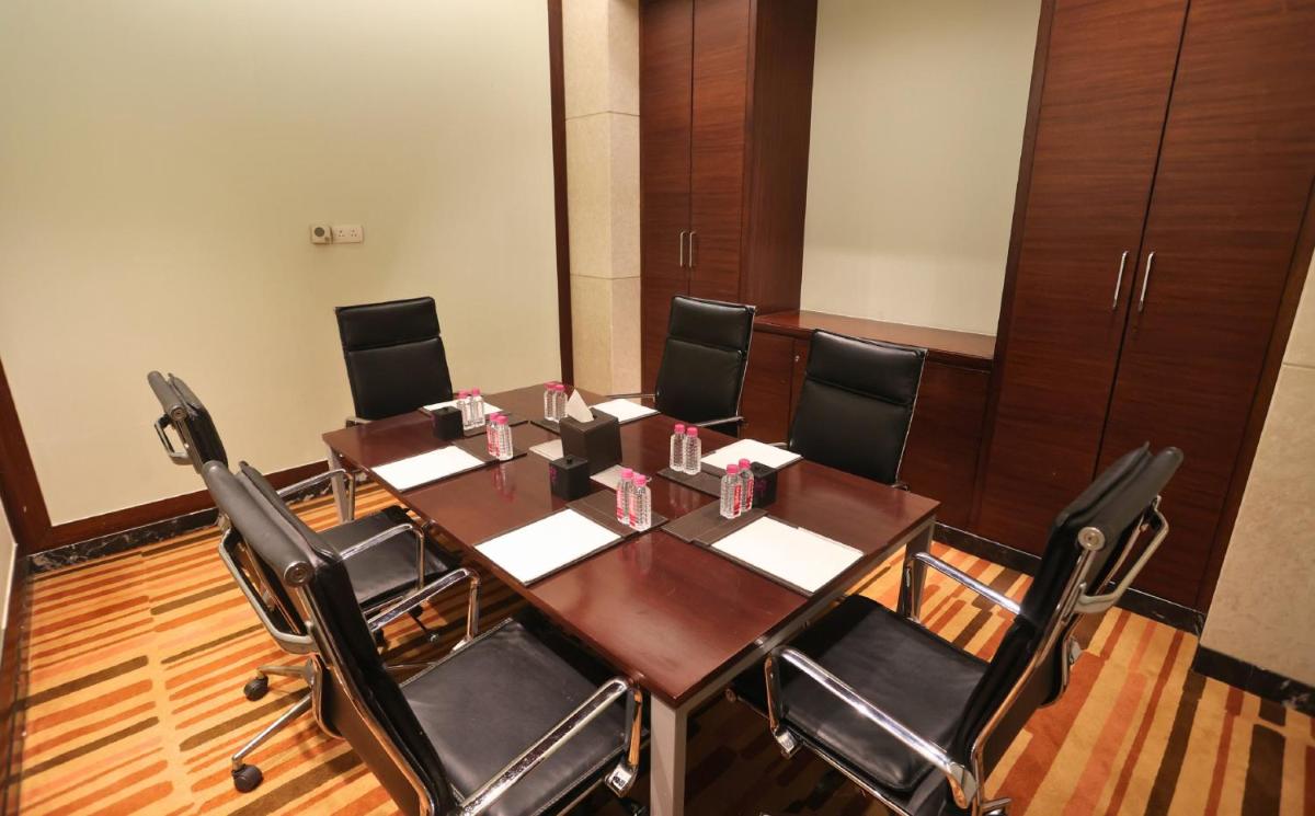 a conference room with a wooden table and chairs at InterContinental Jaipur Tonk Road by IHG in Jaipur