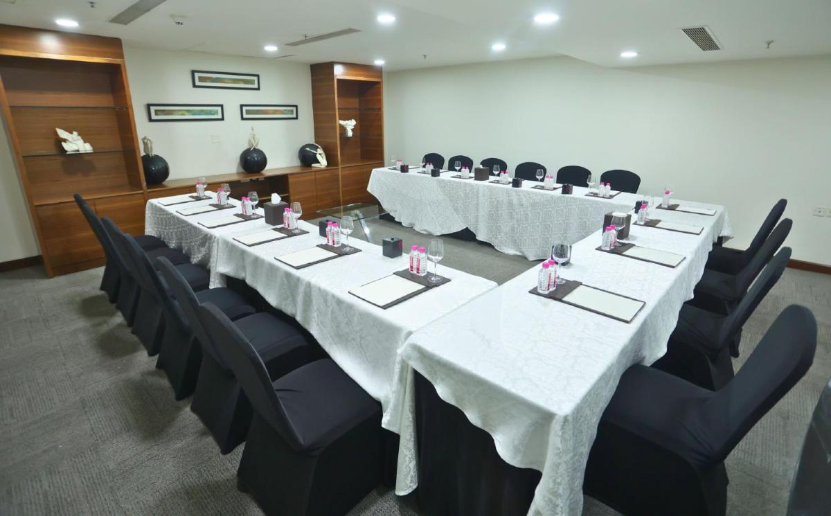 a conference room with long tables and black chairs at InterContinental Jaipur Tonk Road by IHG in Jaipur