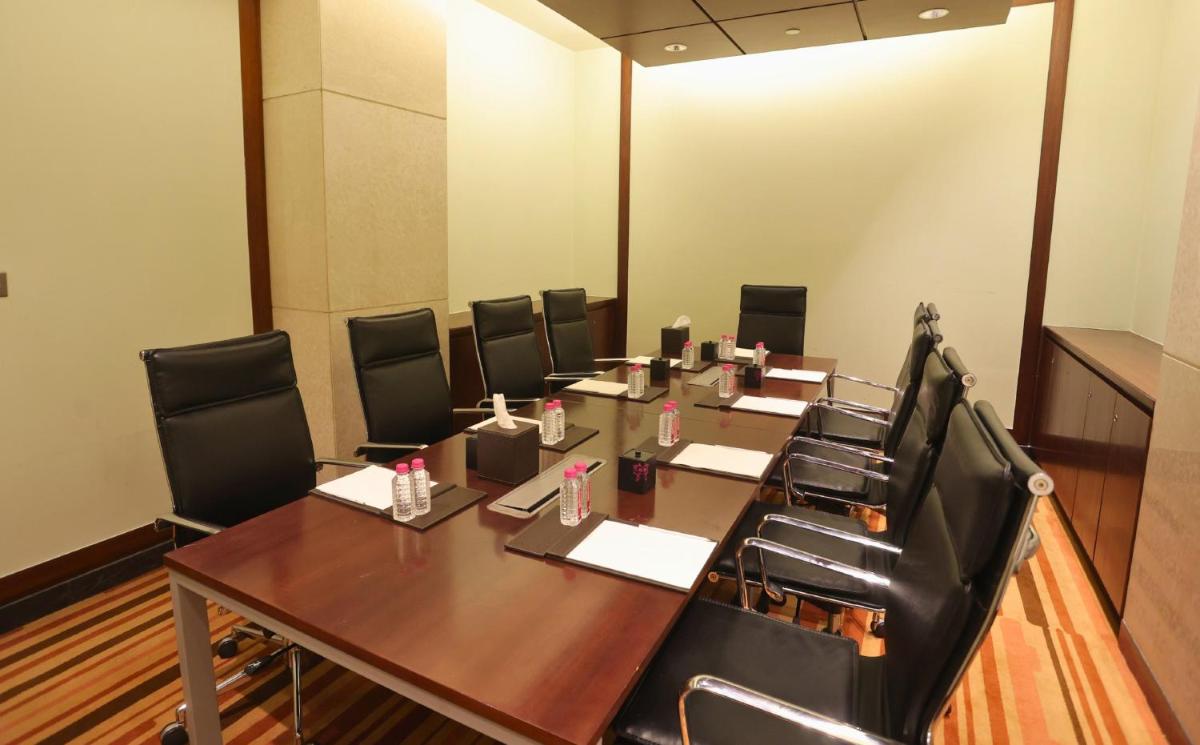 a conference room with a long wooden table and chairs at InterContinental Jaipur Tonk Road by IHG in Jaipur