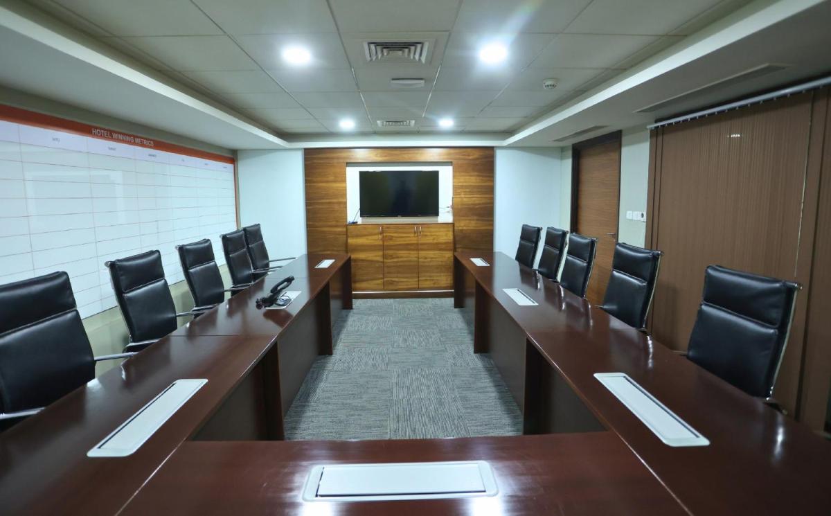 a conference room with desks and chairs and a television at InterContinental Jaipur Tonk Road by IHG in Jaipur