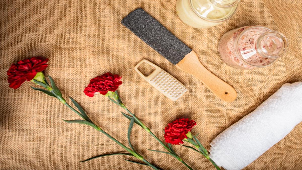 a table topped with red flowers and a knife at Holiday Inn New Delhi Aerocity by IHG in New Delhi