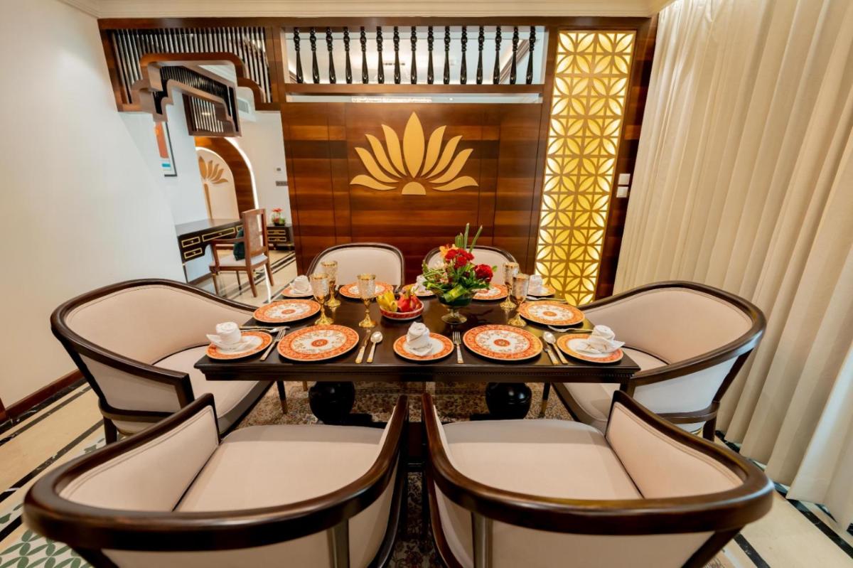 a dining room with a table and chairs at Taj Tirupati in Tirupati