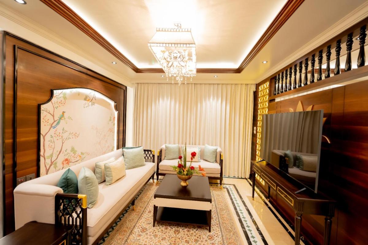 a living room with a couch and a piano at Taj Tirupati in Tirupati