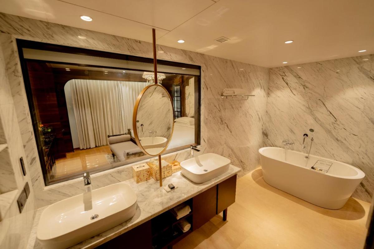 a bathroom with two sinks and a large mirror at Taj Tirupati in Tirupati