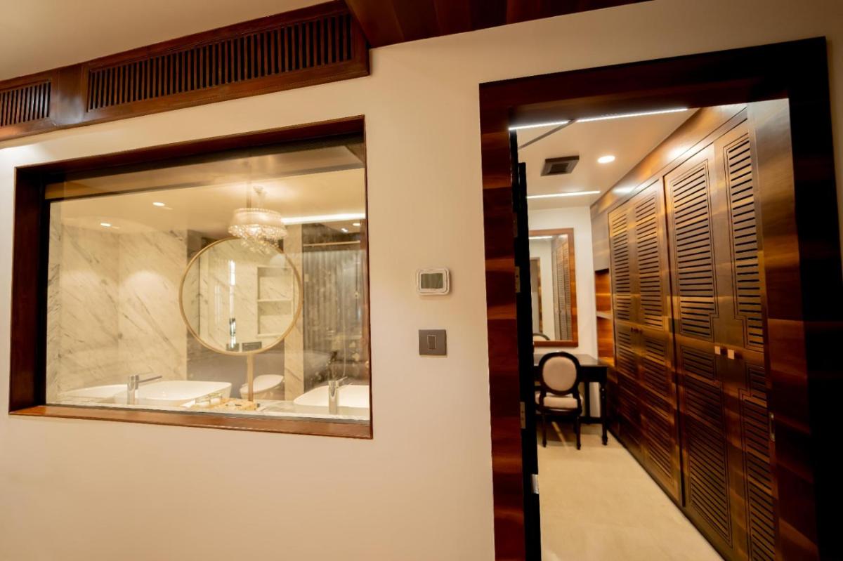 a bathroom with a tub and a mirror at Taj Tirupati in Tirupati