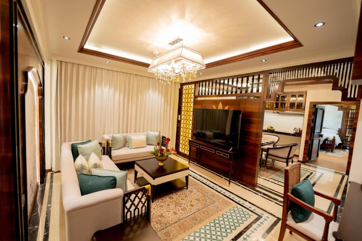 a living room with a couch and a television at Taj Tirupati in Tirupati