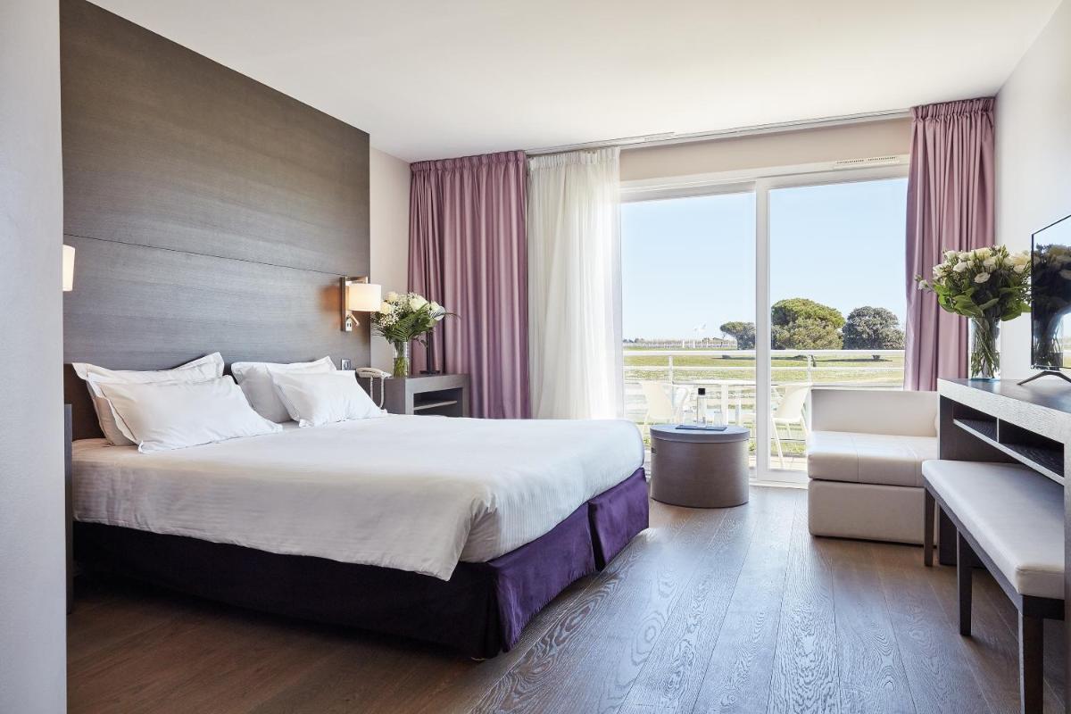 Un ou plusieurs lits dans un hébergement de l'établissement Hôtel Atalante - Relais Thalasso & Spa