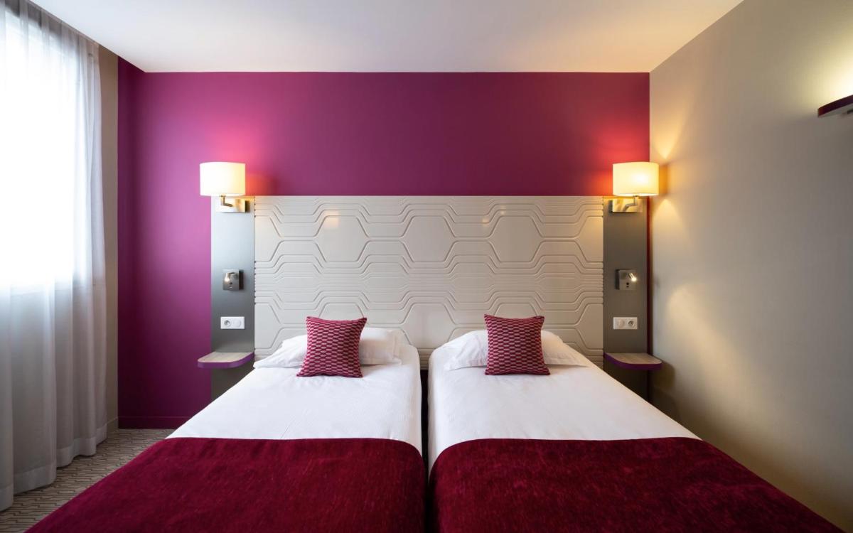 Un ou plusieurs lits dans un hébergement de l'établissement Kyriad Prestige Saint-Malo