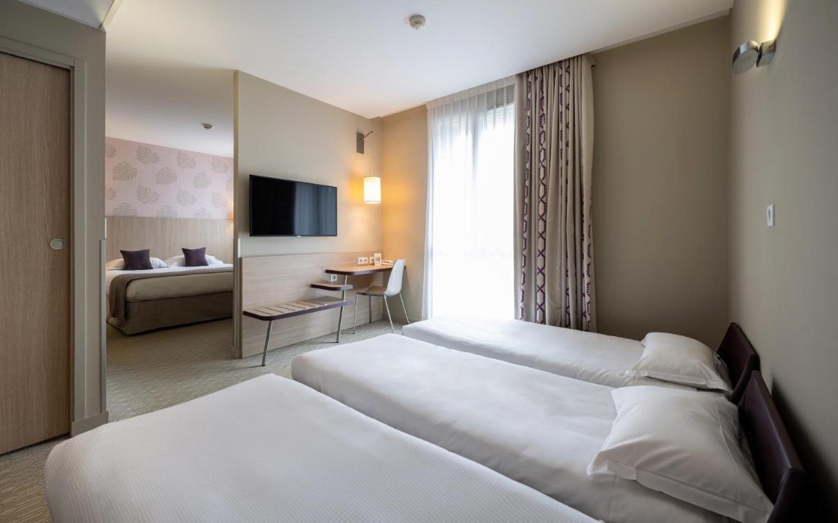Un ou plusieurs lits dans un hébergement de l'établissement Kyriad Prestige Saint-Malo