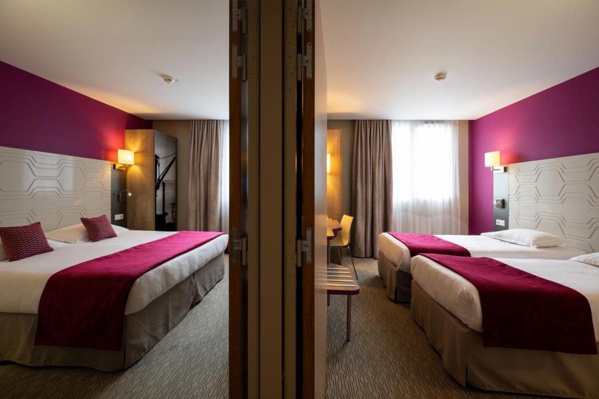 Un ou plusieurs lits dans un hébergement de l'établissement Kyriad Prestige Saint-Malo
