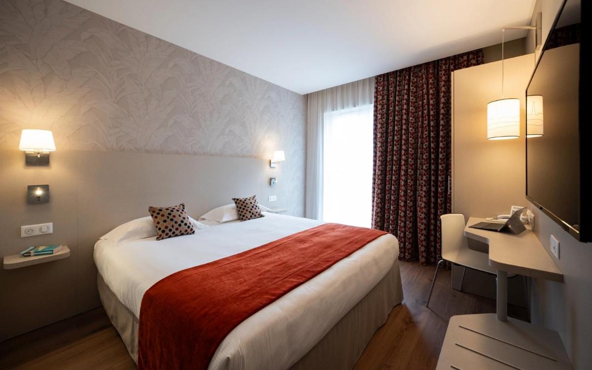 Un ou plusieurs lits dans un hébergement de l'établissement Kyriad Prestige Saint-Malo