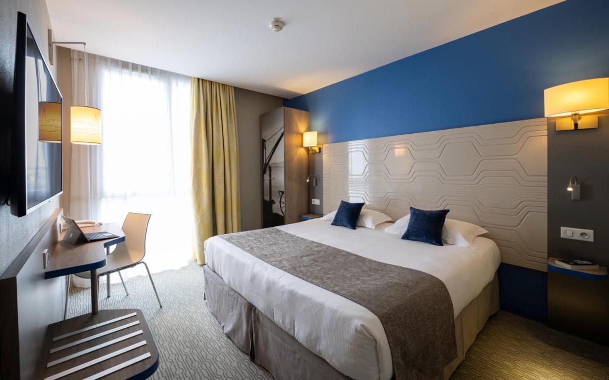 Un ou plusieurs lits dans un hébergement de l'établissement Kyriad Prestige Saint-Malo